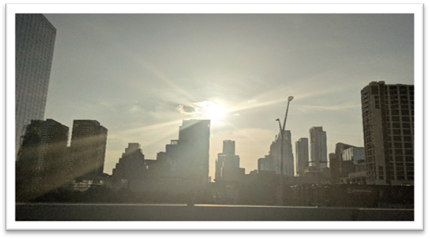 Sun shining through the clouds over a city

AI-generated content may be incorrect.